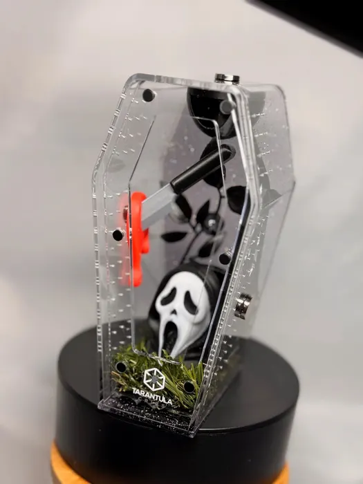 Coffin enclosure with a Ghostface mask and red skeleton
