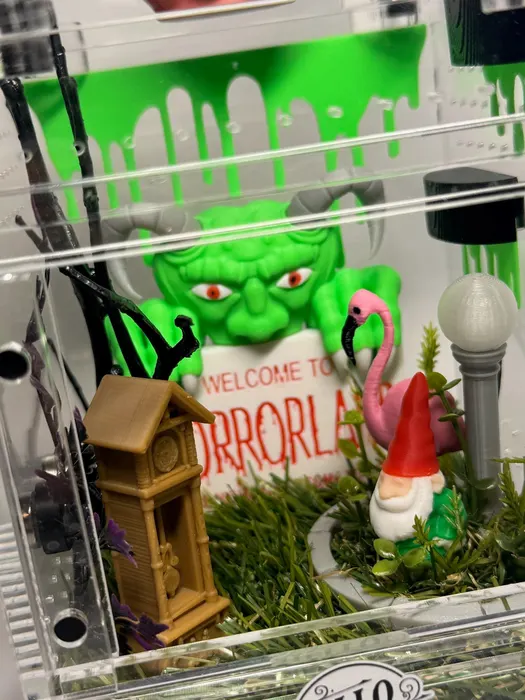 Horrorland enclosure with a green monster and gnome