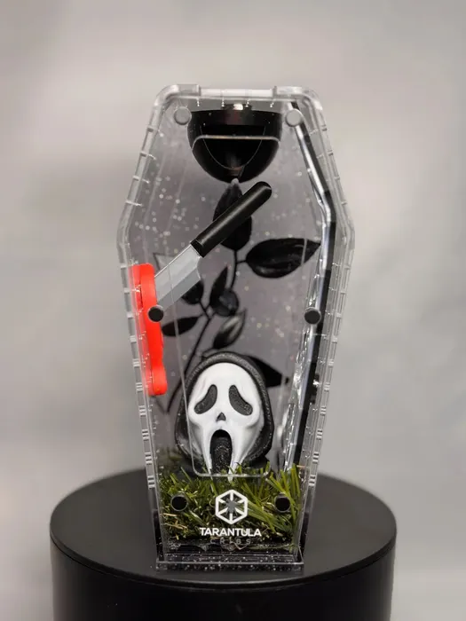 Coffin enclosure with a Ghostface mask and knife