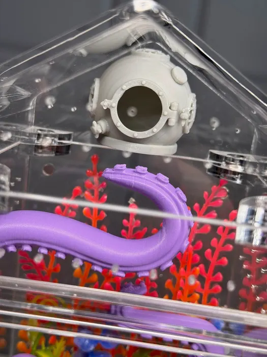 Enclosure with a diving helmet and purple tentacle