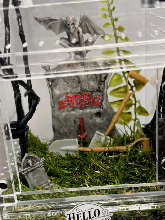 Graveyard enclosure with a bat and tombstone
