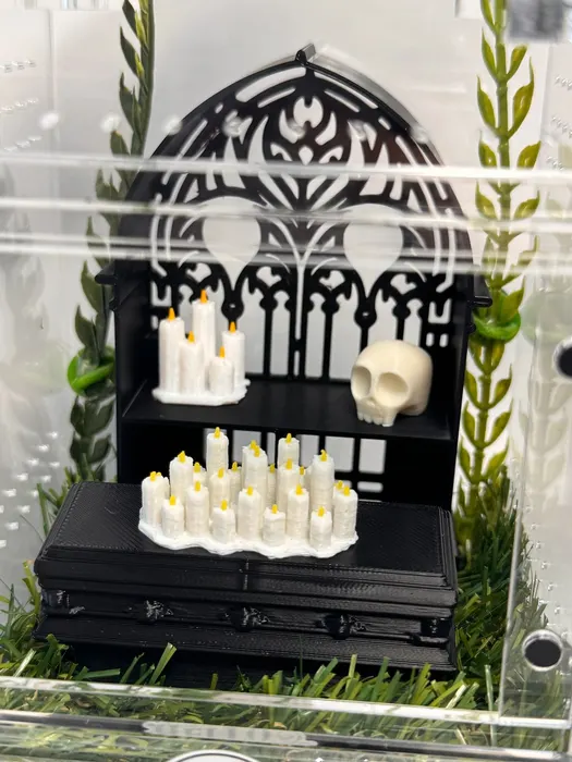 Enclosure with candles, a skull, and iron gate