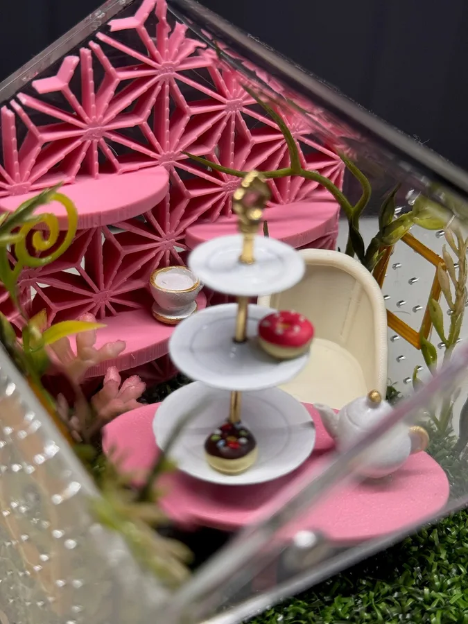 Pink tea party enclosure with tiered cake stand