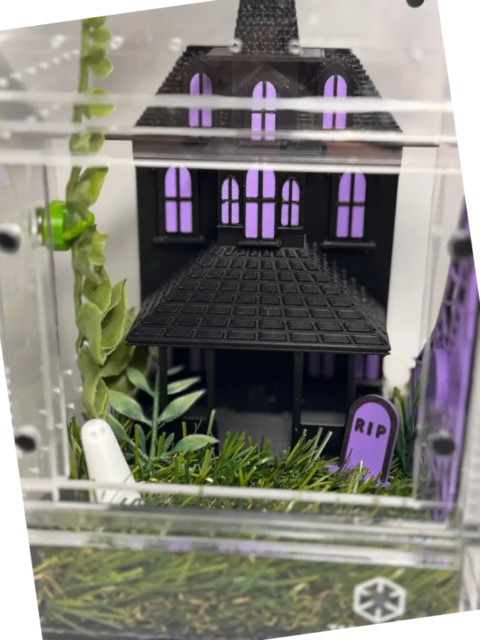 Haunted house enclosure with purple windows and a ghost